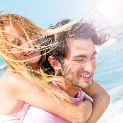An attractive couple fooling around on the beach
