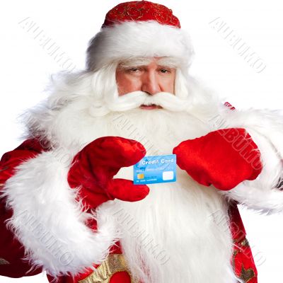 Traditional Santa Claus holding and sowing credit card while giv