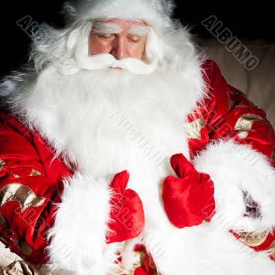 Santa sitting with a sack indoor at dark night room