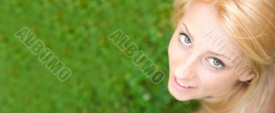 Smiling beautiful woman laying on grass. Smiling. Photo from abo