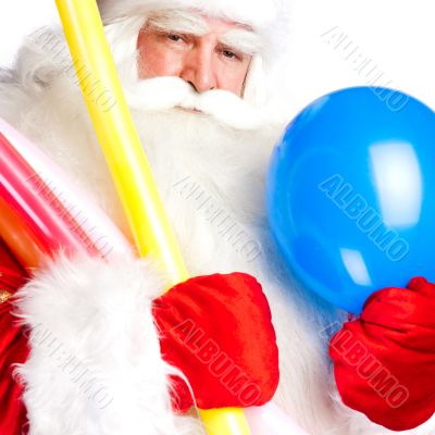 Traditional Santa Claus holding balloons for children. Isolated 
