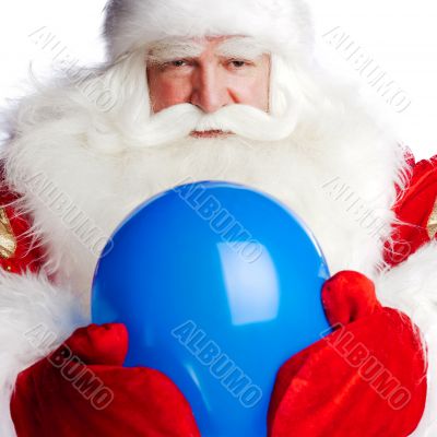Traditional Santa Claus holding balloons for children. Isolated 