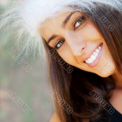 Portrait of a sexy young female smiling in a park and looking at