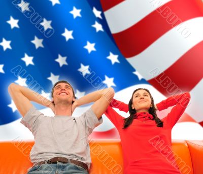 Smiling beautiful couple sitting on a sofa and dreaming about ne