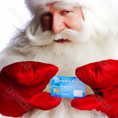 Traditional Santa Claus holding and sowing credit card while giv