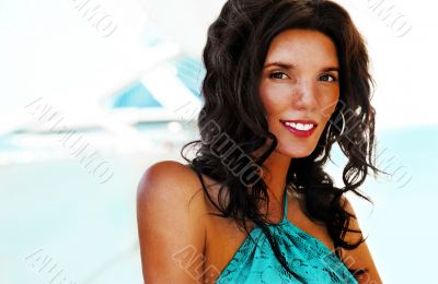 Portrait of a pretty young woman standing at modern resort and l