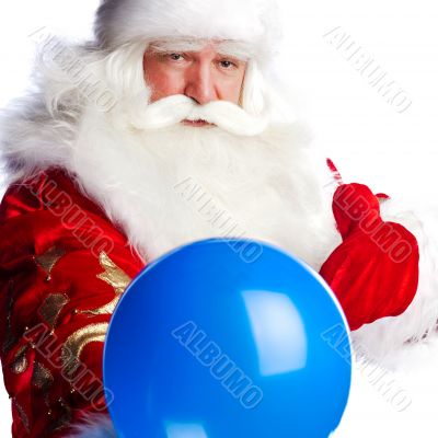 Traditional Santa Claus holding balloons for children. Isolated 