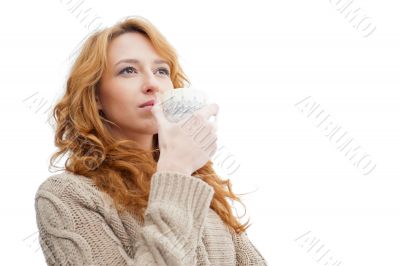 Portrait of beautiful red hair girl drinking coffee on winter ba
