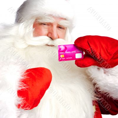 Traditional Santa Claus holding and sowing credit card while giv
