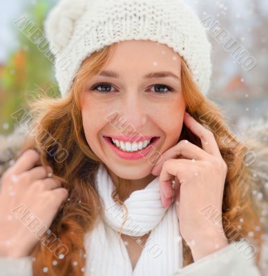 Portrait of beautiful young red hair woman outdoors in winter lo
