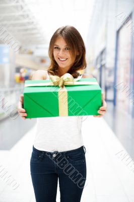 Portrait of young excited pretty woman standing inside shopping 