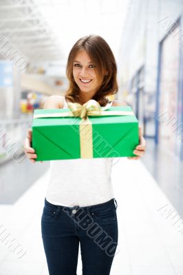 Portrait of young excited pretty woman standing inside shopping Portrait of young excited pretty woman standing inside shopping