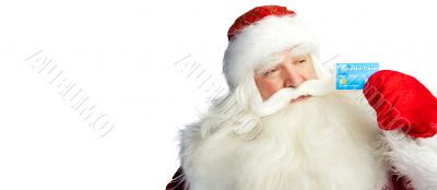 Traditional Santa Claus holding and sowing credit card while giv