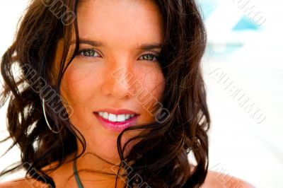 Portrait of a pretty young woman standing at modern resort and l
