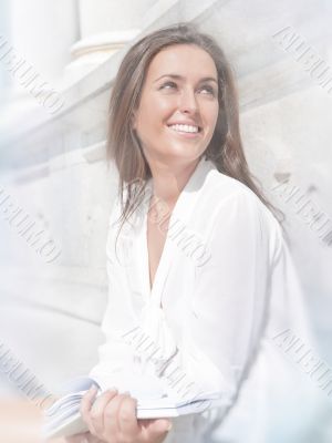 Beautiful dark-haired pretty girl in jeans and white blouse read