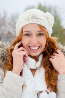 Portrait of beautiful young red hair woman outdoors in winter lo