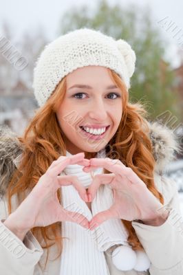 Portrait of beautiful young red hair woman outdoors in winter lo
