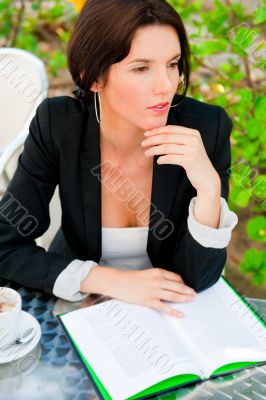 Portrait of a young attractive business woman sitting at outdoor