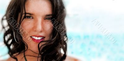 Portrait of a pretty young woman standing on beach at modern res