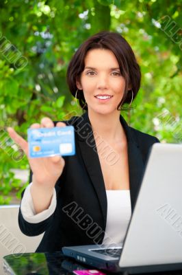 Business woman making payments online using laptop and credit ca