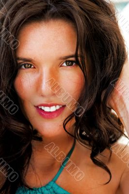 Portrait of a pretty young woman standing on beach at modern res
