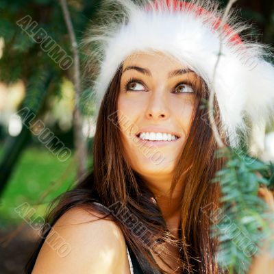 Portrait of a sexy young female smiling in a park and looking at
