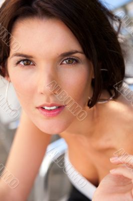 Portrait of pretty young businesswoman sitting outdoor at cafe a