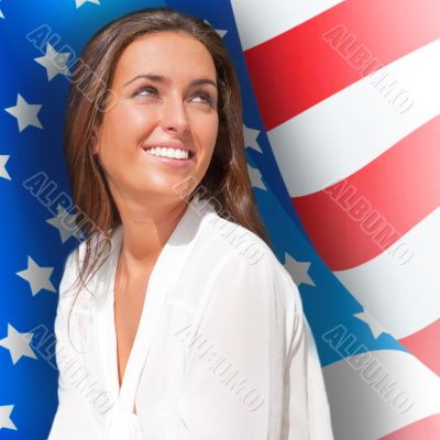 Portrait of a pretty young woman &ocirc;&iuml;&ocirc;&oslash;&ograve;&ucirc;&aring; an American flag , smil