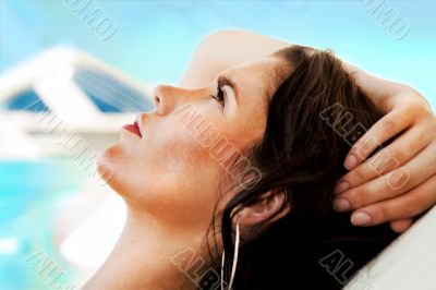 Pretty young woman resting at modern resort. Hotel building at t