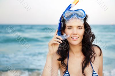 Young hispanic woman with wet skin and with a snorkel standing o