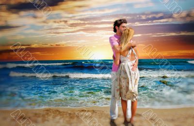 Portrait of young couple in love embracing at beach and enjoying