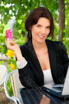 Business woman making payments online using laptop and credit ca