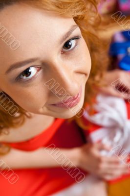 Christmas woman near a Christmas tree holding big gift box while