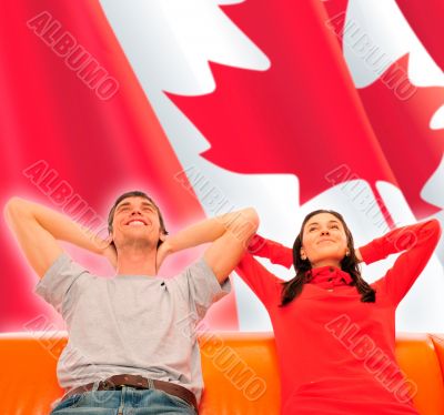 Smiling beautiful couple sitting on a sofa and dreaming about ne