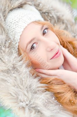Portrait of pretty girl at winter background wearing warm clothe