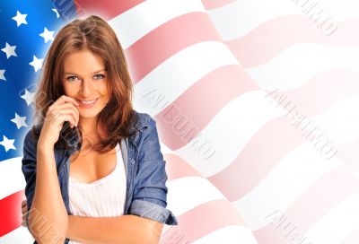 Portrait of a pretty young woman &ocirc;&iuml;&ocirc;&oslash;&ograve;&ucirc;&aring; an American flag , smil