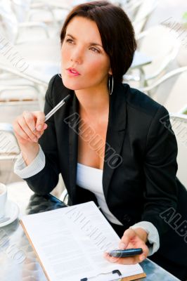 Business woman working with documents while having lunch or brea