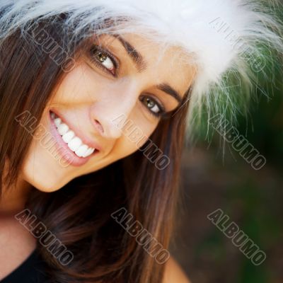 Portrait of a sexy young female smiling in a park and looking at