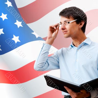 Portrait of adult man wearing formal clothes and glasses holding