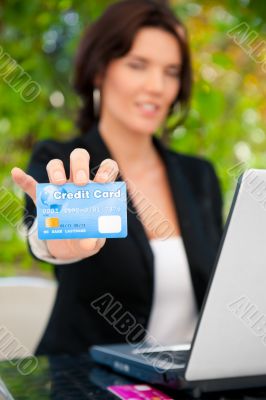 Business woman making payments online using laptop and credit ca