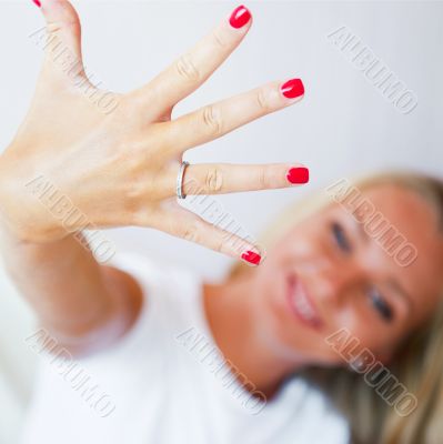 Happy young woman showing her proposal ring from her boyfriend. 