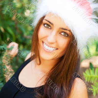 Portrait of a sexy young female smiling in a park and looking at