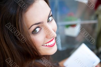 Closeup portrait of a lovely young woman writing a diary