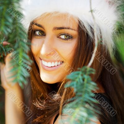 Portrait of a sexy young female smiling in a park and looking at