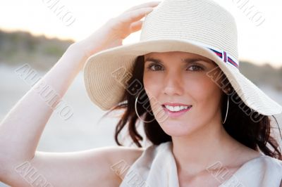 Summer portrait of beautiful woman wearing hat. Vacation at warm