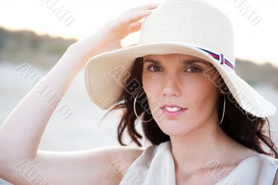 Summer portrait of beautiful woman wearing hat. Vacation at warm