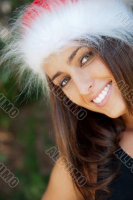 Portrait of a sexy young female smiling in a park and looking at