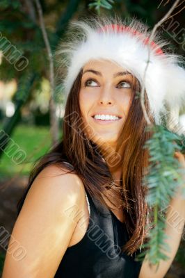 Portrait of a sexy young female smiling in a park and looking at
