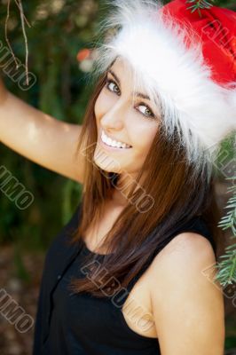 Portrait of a sexy young female smiling in a park and looking at