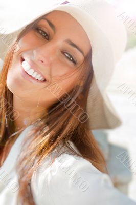 Portrait of pretty cheerful woman wearing white dress and straw 